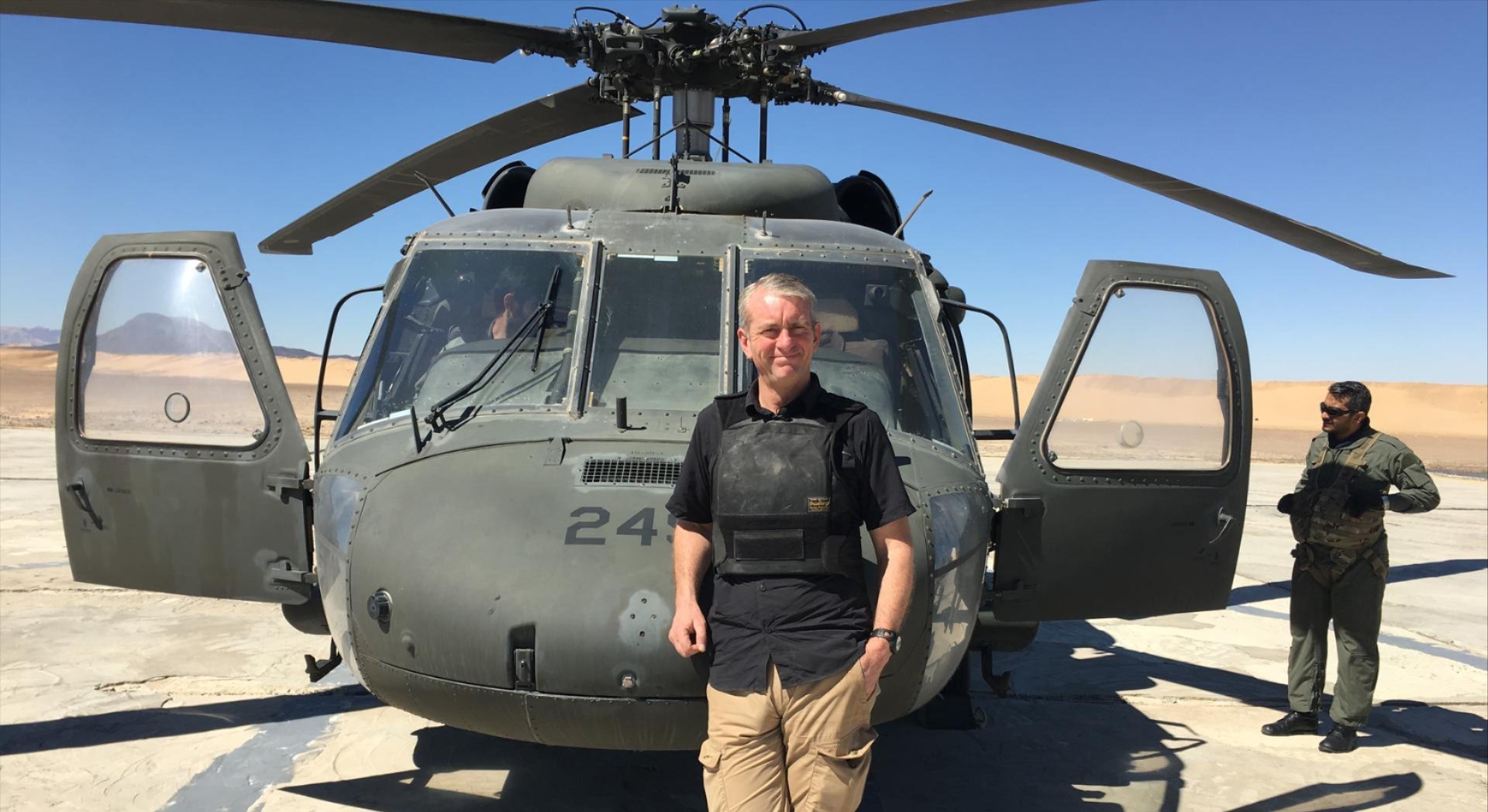 CNN's Nic Robertson stands in front of a helicopter