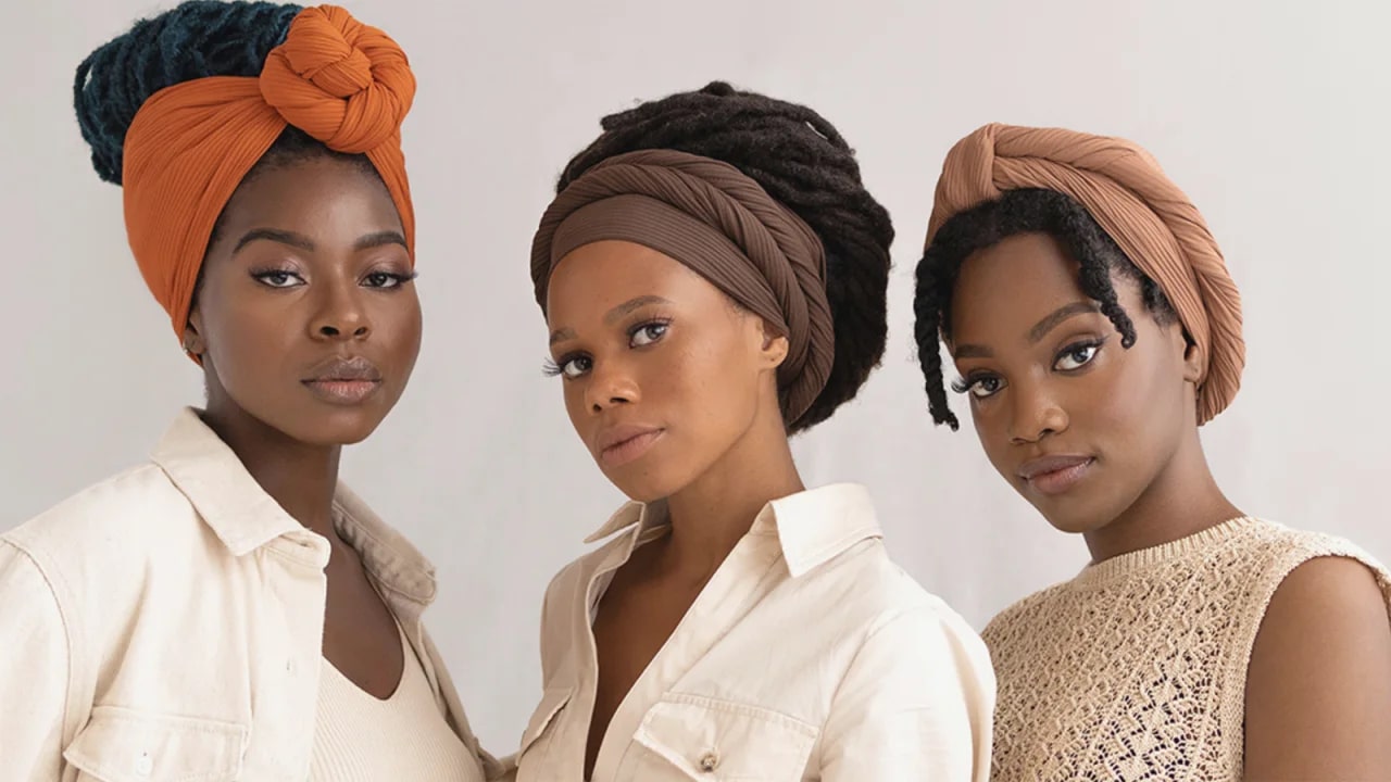 Three women wearing headwraps